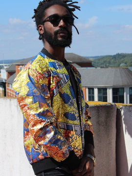 Chaqueta del festival en letra africana de oro