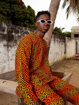 Con un traje Africano de samakaka rojo.